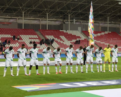 Republic of Ireland players bow their heads and wear black armbands during the Israel anthem.