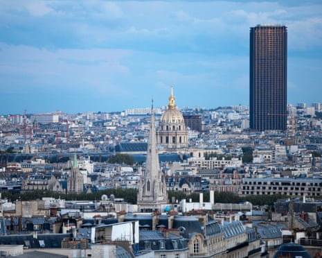 A tall, dark skyscraper stands out over Paris's other buildings