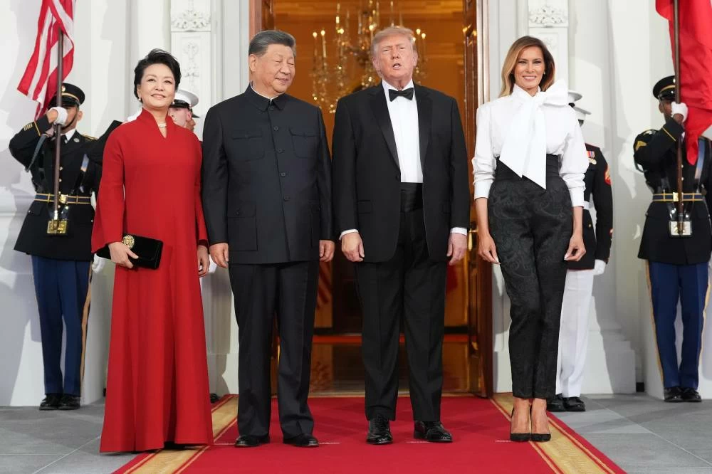 US President Donald Trump and first lady Melania Trump pose for a photo with China's President Xi Jinping and his wife Peng Liyuan as they arrive at the North Portico of the White House for a State Dinner, Thursday, Sept. 24, 2026, in Washington. (AP)