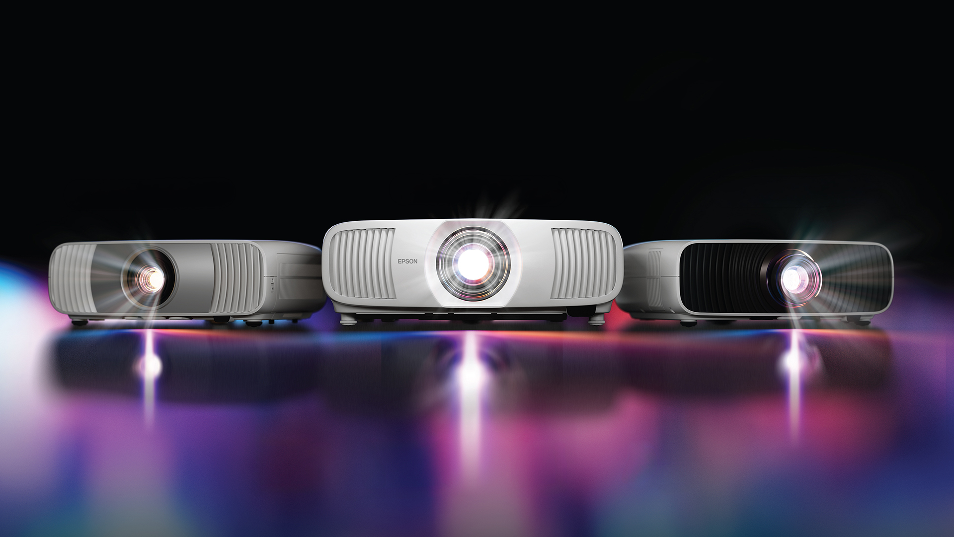 The 3 new Epson projectors on a shiny background.