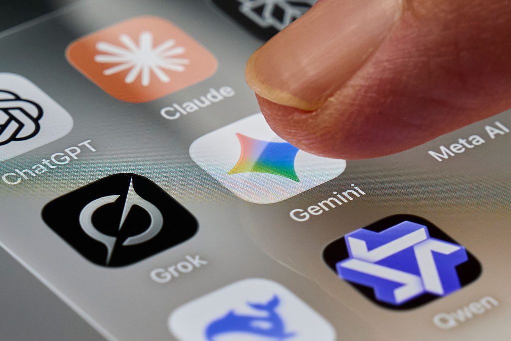 A finger taps the Gemini app icon on a smartphone screen.