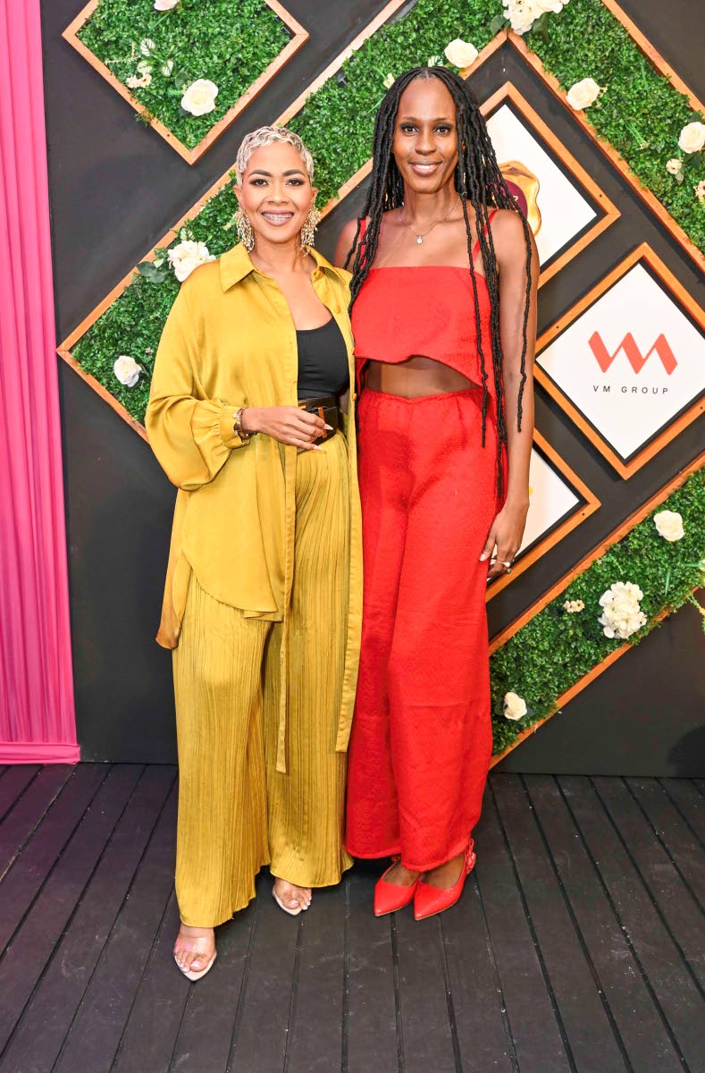 Standing out in bold hues, media personality Debbie Bissoon (left) catches up with fashion designer Kadian Nicely.