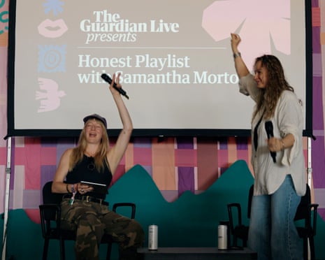 Samantha Morton and Kate Hutchinson on stage at green man raise microphones, dancing during an event