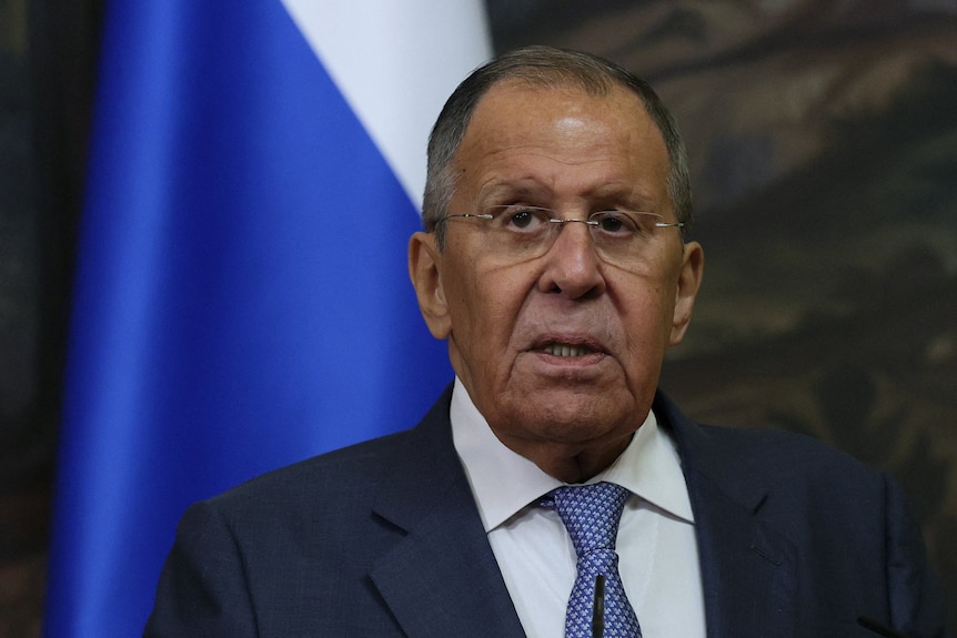 A shoulders-up shot of Sergei Lavrov wearing a suit on a blurred background.
