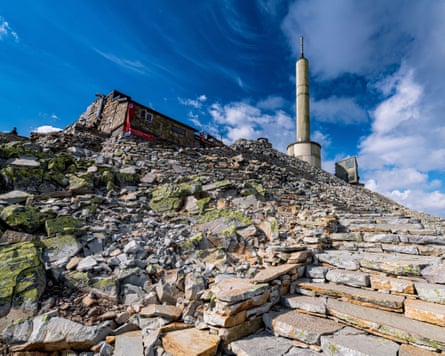A stone hut on top of a rocky mountain