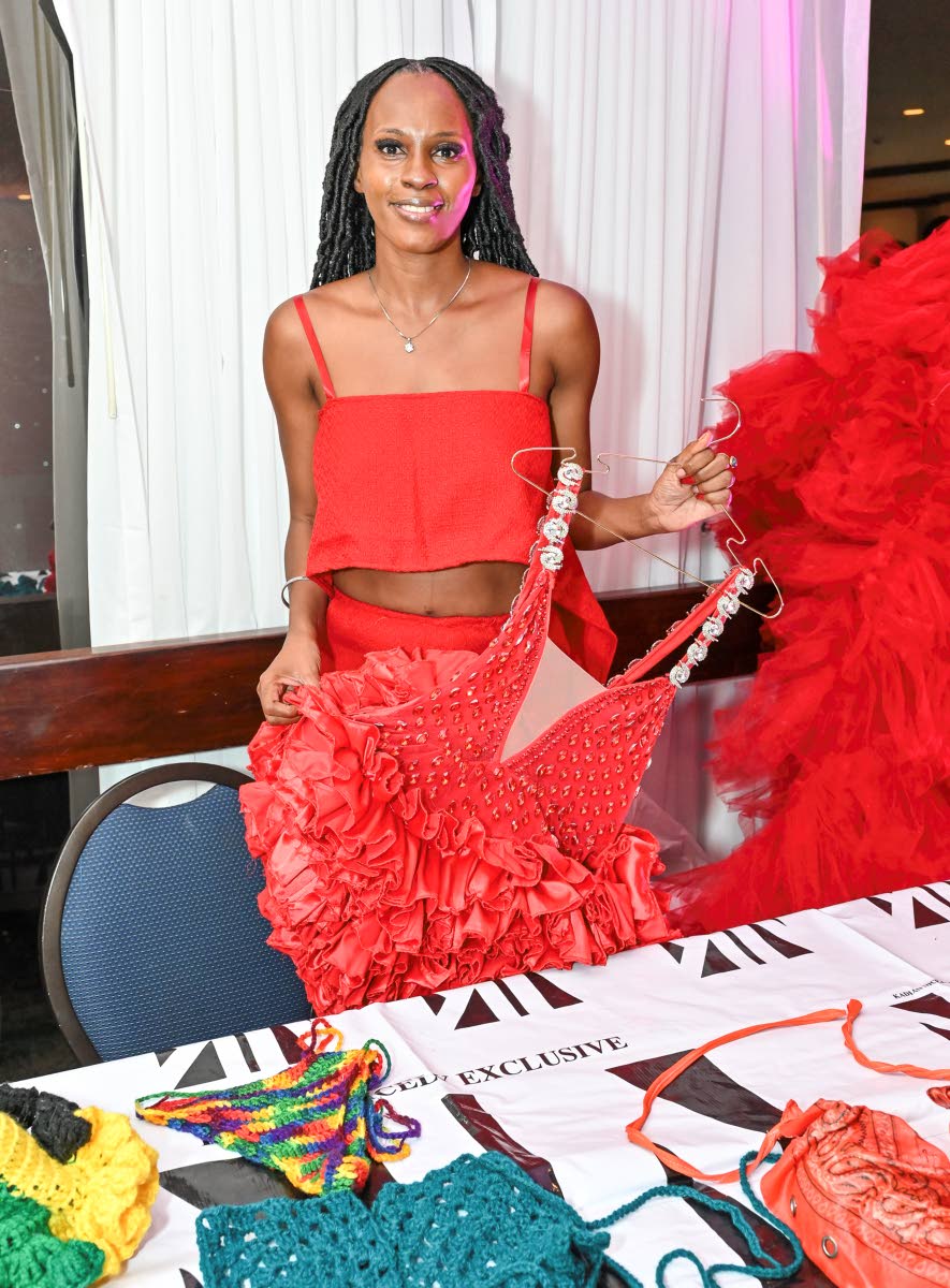 Designer Kadian Nicely happily showcases pieces from her collection.