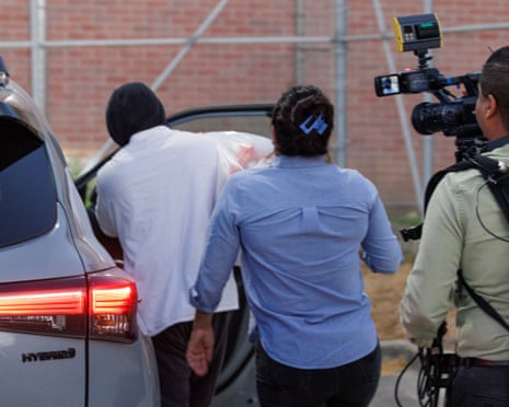 two people get into a car