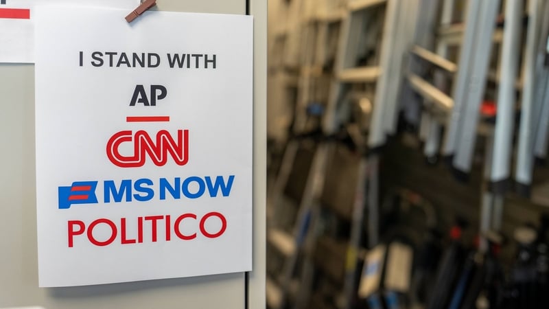 A poster reading "I Stand With AP, CNN, MS NOW, and Politico" near the Press Briefing Room of the White House