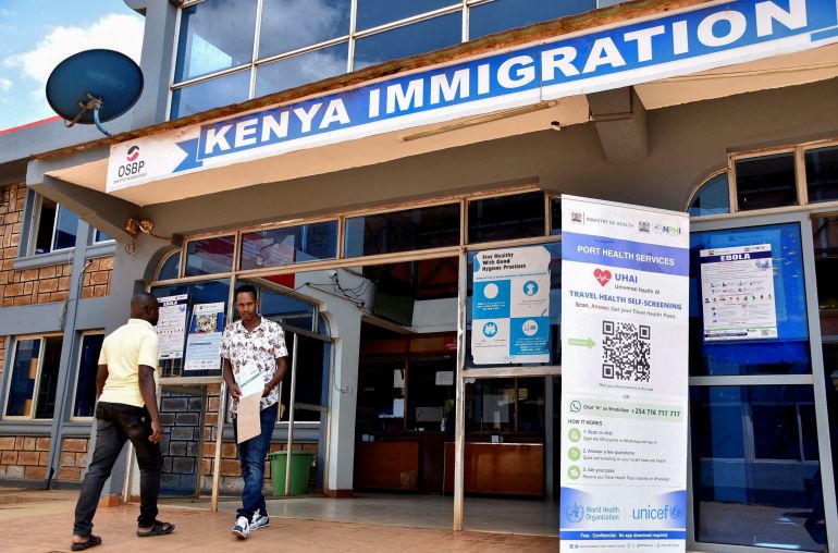 Travellers walk at the Kenya immigration services to access port health services at the Busia One Stop Border Post, crossing-point between Kenya and Uganda, after a man who had been living in the Democratic Republic of Congo travelled and died of a new Ebola outbreak involving the Bundibugyo species at the Nairobi Hospital, in Busia, Kenya October 8, 2026 [James Keyi/Reuters]